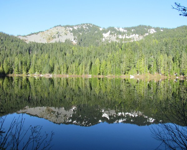 Alpine lake with a peak reflected in the water.