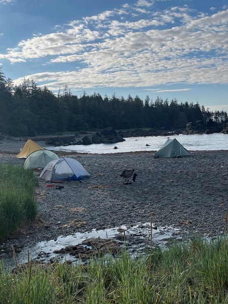 Several tents pitched on gravel at Nordstrom Creek